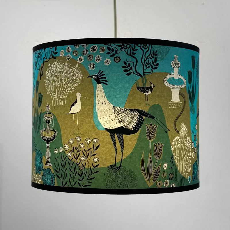 Fountains Lampshade Turquoise Decorative lampshade with bird and garden design on a plain background