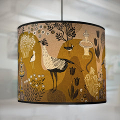Decorative lampshade with bird and nature design on a plain background
