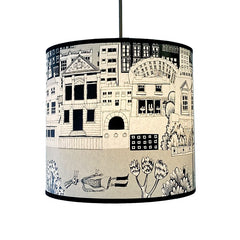 lampshade with print of black and grey buildings and skeleton lying under water