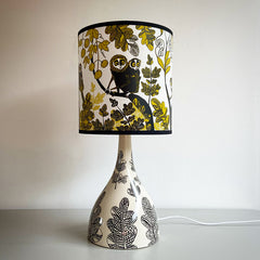 Lush Designs Cream and black ceramic lamp base with shade printed with Lorises in the jungle in black and yellow