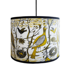 Lush Designs lampshade printed with partridges and songbirds in a woodland setting in mustard and black