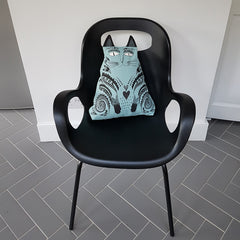 Lush Designs cat-shaped cushion on black modern chair