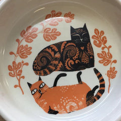 Lush designs cat bowl, the inside with a print of two recumbent cats in orange and black