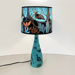 Bird print lamp base and lampshade in strong trquoise and black with touches of orange
