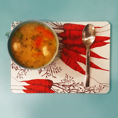 Carrot print table mat with vegetable soup