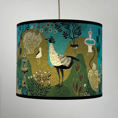 Decorative lampshade with bird and garden design on a plain background