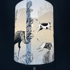 Lampshade with black and white animal illustrations on a beige background