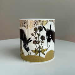 China mug with picture of donkey and flowers in black, gold and olive green