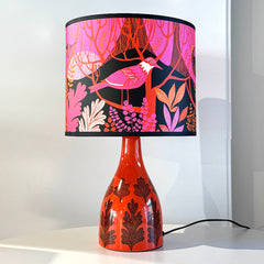 Table lamp with a colorful pink and orange shade on a white background
