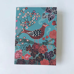 Greetings card with a bird and floral design on a blue background