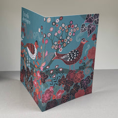 Card with bird and floral design on a gray background