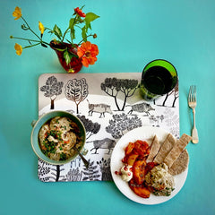 table set with colourful mediterranean food on a mat with wild boar print