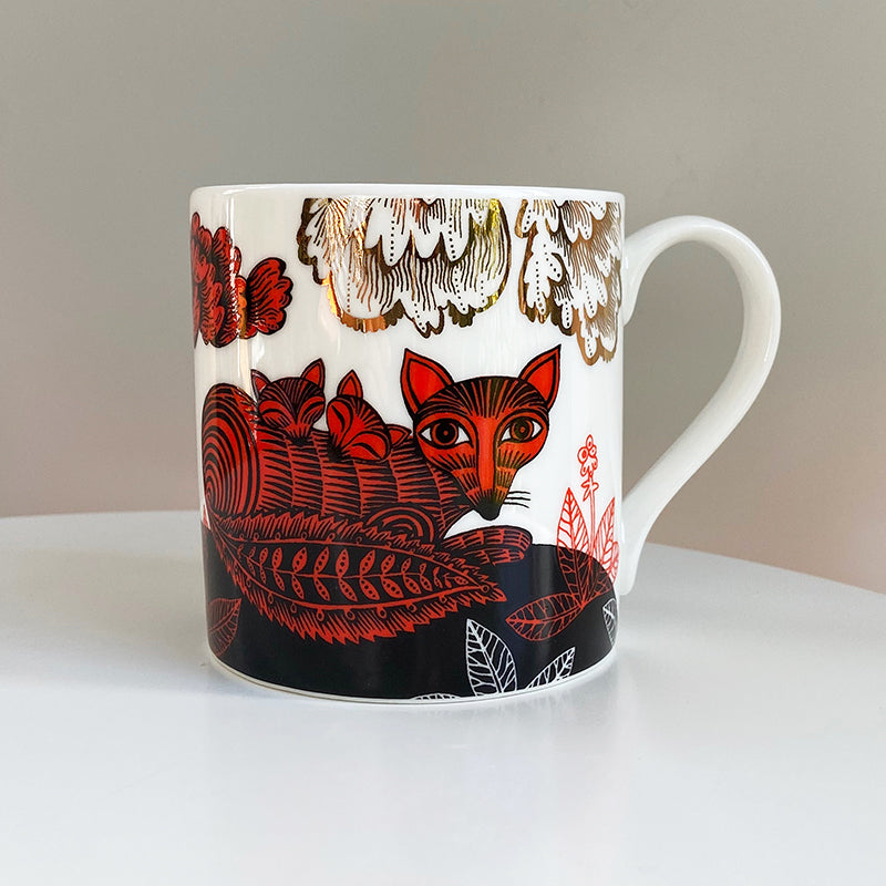 china mug with red and black fox and cubs with gold lustre