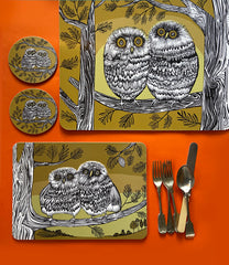 Lush Designs owl mats and coasters on an orange background