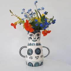Lush designs lady-shaped vase with spring flowers in
