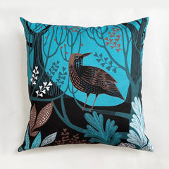Shades of blue, black and brown cushion printed with a thrush bird in woodland setting