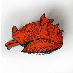 Lush Designs red and black enamel brooch shaped like a sleeping fox and cubs
