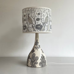 Lush Designs ceramic bottle-shaped lamp base with bird-print shade in cream, grey, black and white