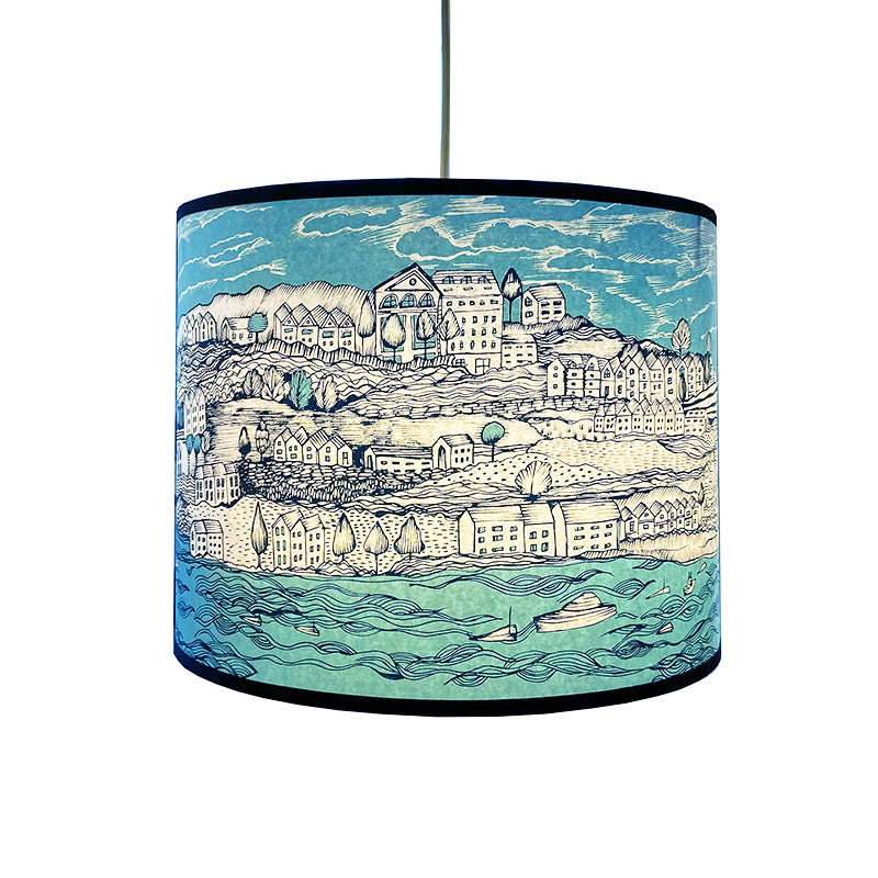 n lampshade printed with seaside town in shades of blue