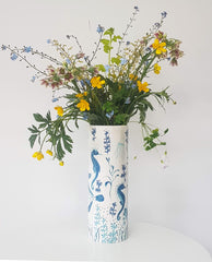 vases printed with seahorses in shades of blue, filled with wild buttercups and forget-me-nots vase 