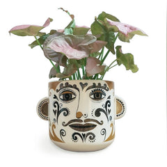 Lush designs plant pot printed with patterned clown face and featuring 3D ears on ether side 