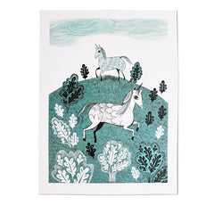 Lush Designs print on art-paper of two unicorns on a hillside with trees in Turquoise and black