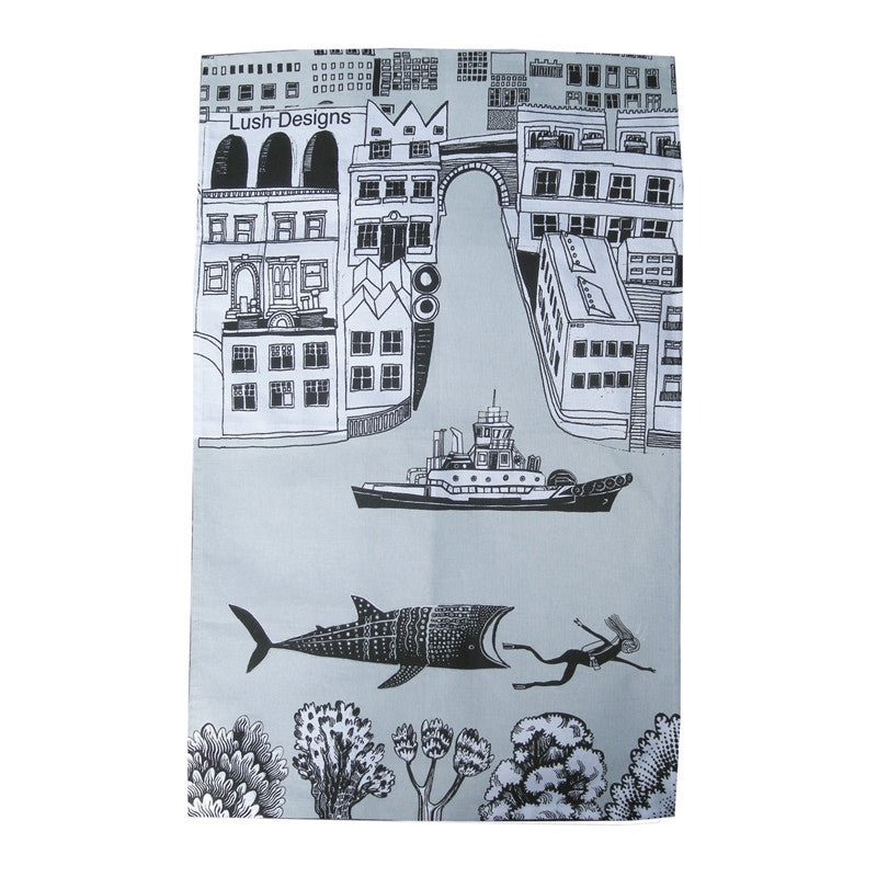 Lush Designs London and the Thames on a tea towel in light grey and black on white with illustration of whale shark chasing a swimmer in the water!