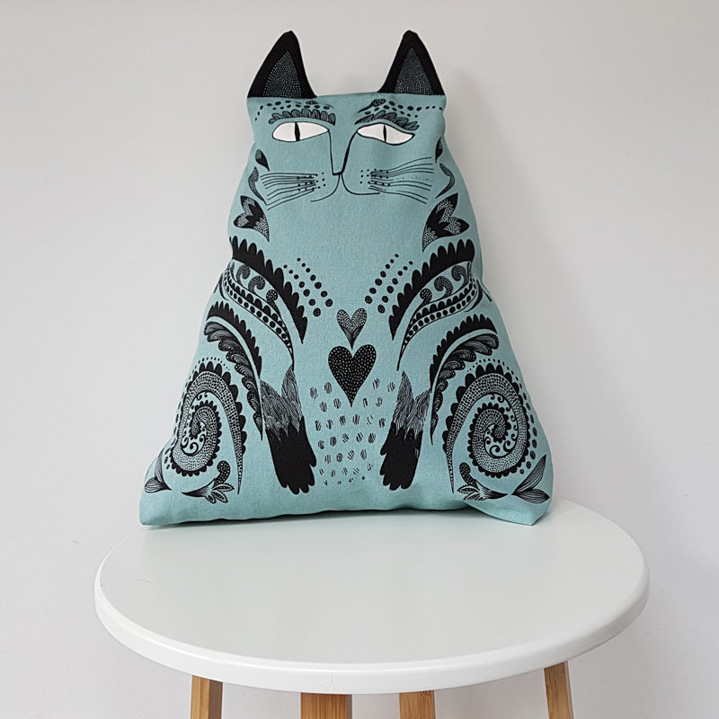 Lush Designs cat-shaped cushion on a white modern stool