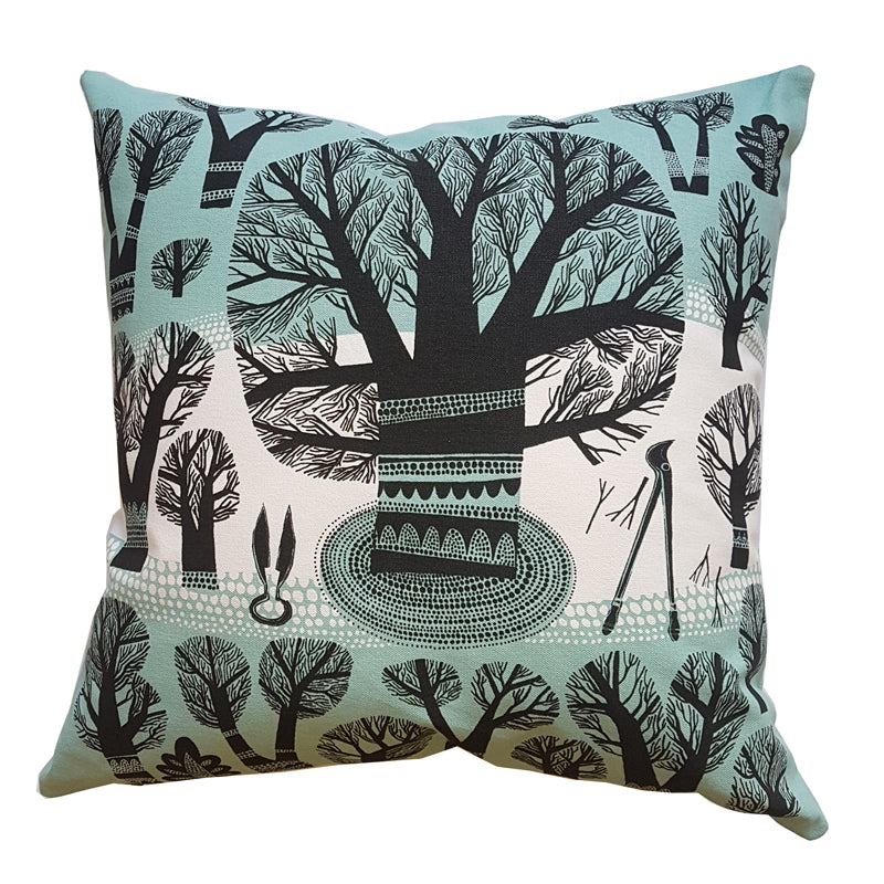 Lush designs cushion with print of winter trees and garden tools in black and teal on white