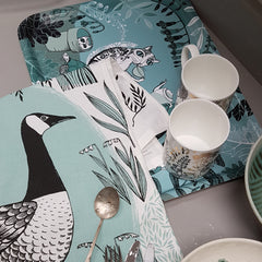 cat print tray with cups on it and goose print tea towel and spoon