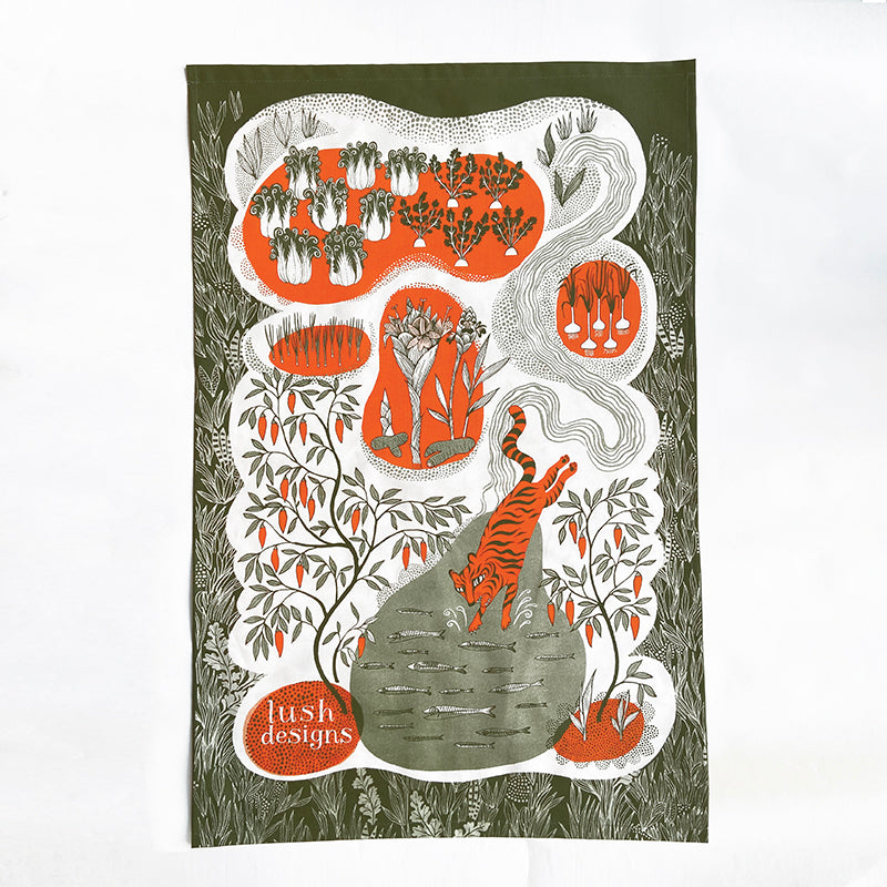 Lush Designs tea towel printed with vegetable garden and leaping tiger