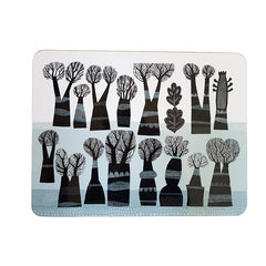 Lush Designs table mat with a design of black winter trees on a pale blue and white background