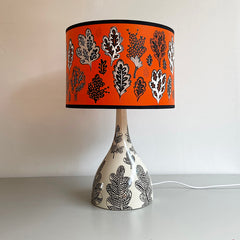 Lush Designs Cream and black ceramic lamp base with orange and black leaf print lampshade