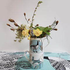 Lush designs mugs with goose and rabbit print containing yellow flowers