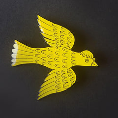Lush Designs yellow enamel bird brooch on a black background